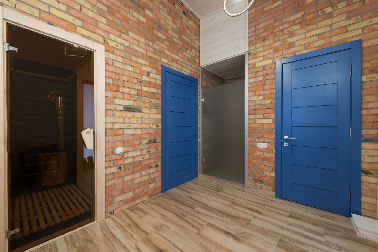 A compact sauna room opening from an ordinary home hallway